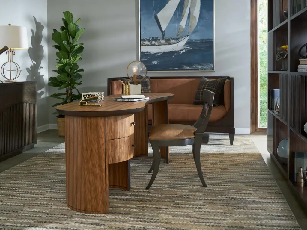 a living room with a desk, chair, and bookcase by Old Biscayne
